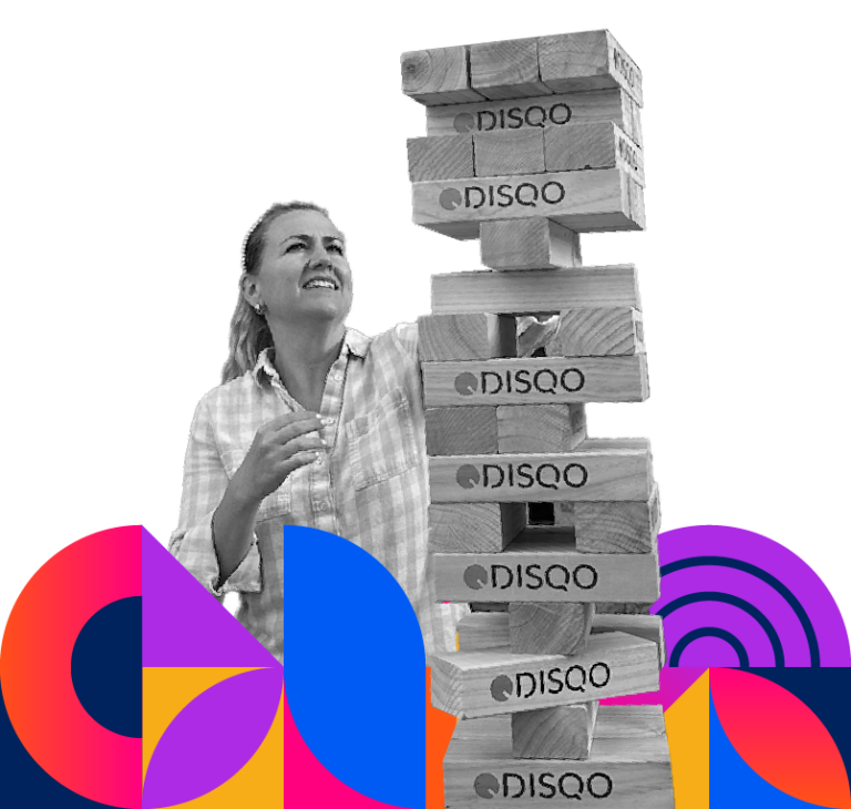 DISQO employee playing DISQO branded giant Jenga.